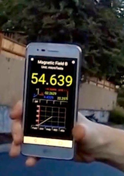android cell phone showing Ultimate EMF Detector measuring elevated ambient electromagnetic fields